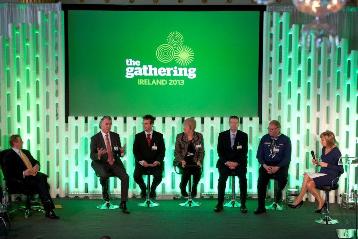 Panel on stage with An Taoiseach left, Mary Kennedy right and Adrian Gallagher 4th left of the panellists.